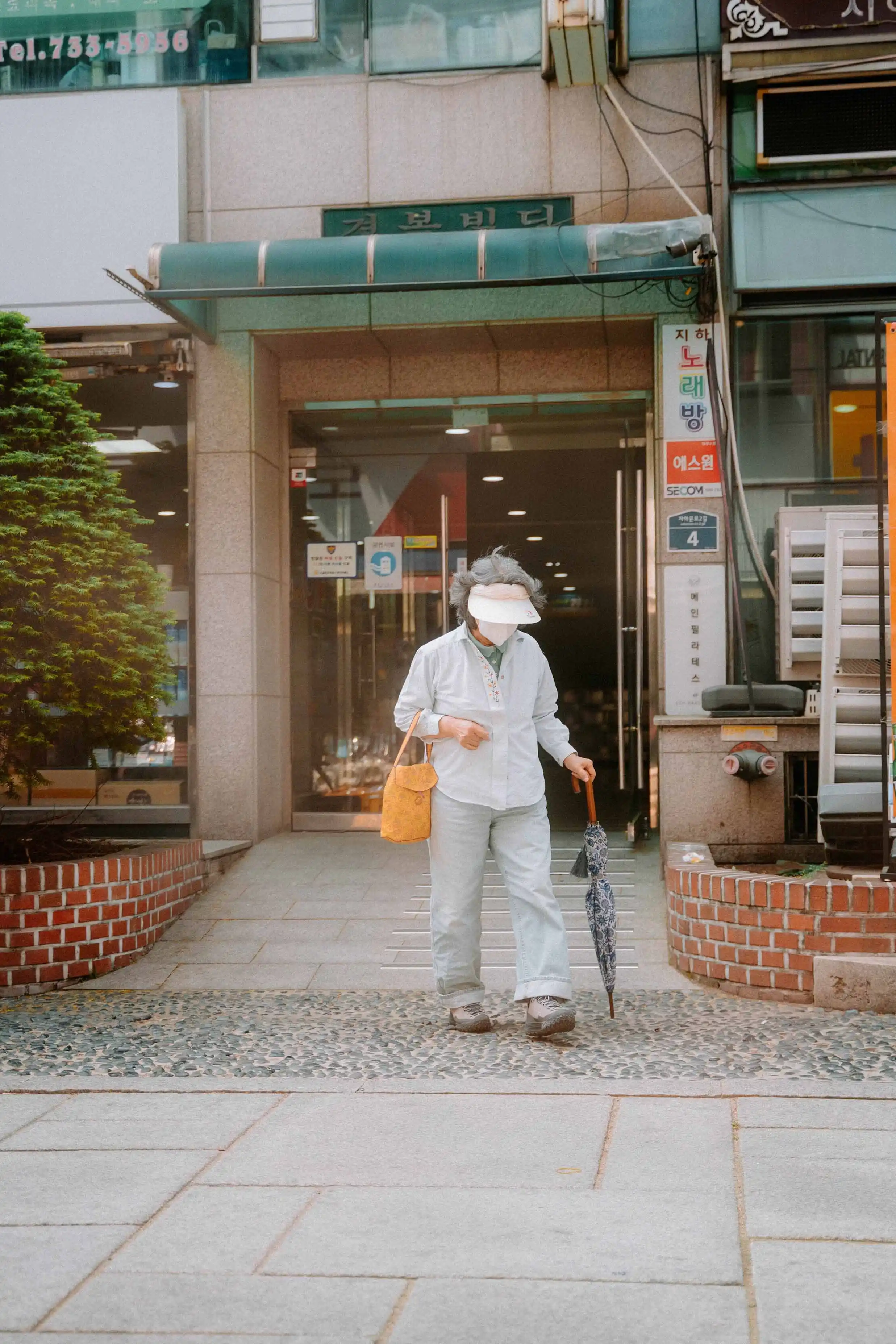 Grandmother walking in a small street in Seoul